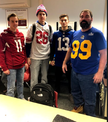  Three senior boys, Max Kaull, Jason Slehtowsky and Tyler Kamm pose with Business tecaher, Mr. Hodge on football friday. There were some heated debates with the Superbowl being that Sunday.