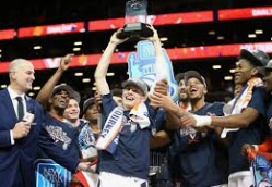 Kyle Guy hoisting up the National Championship Trophy while surrounded by his teammates