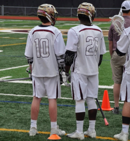 Connor Smith (left) and Royale Richards (right) standing on the sidelines during their game