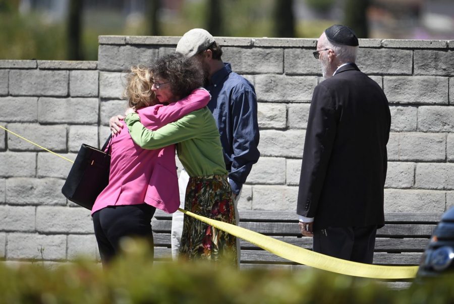 On Saturday April 27th, 2019, members comfort each other outside of the Synagogue. 