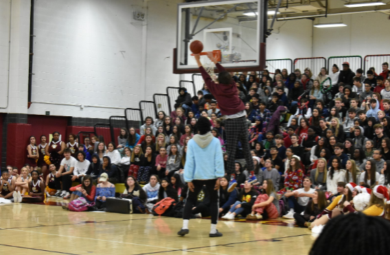 Trevor Anthony dominates the court as he jumps up to dunk the ball into the net during the hockey vs. basketball shootout. 