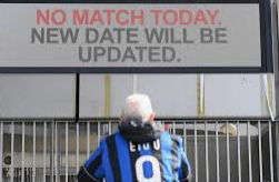 An Atalanta BC fan in Italy stands outside the gate of Gewiss Stadium
Source: dw.com