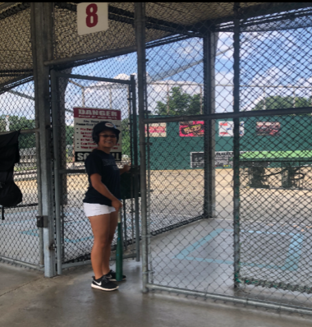 Heather Kim prepares to head into the batting cages and hit some softballs. 