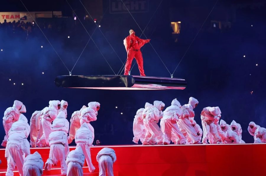 Rihanna on a movable stage performing at Super Bowl LVII .
