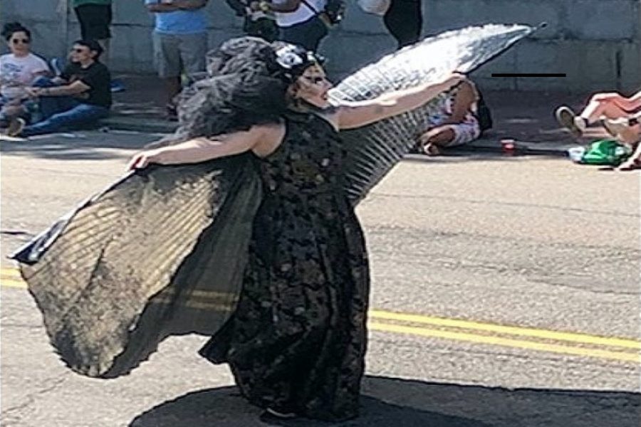 Drag queen performer strutting down Boston pride. Photo captured by Cat Martino.
