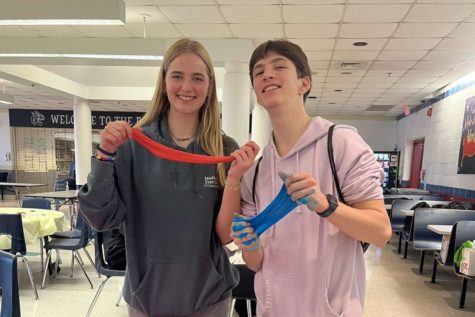 Juniors Morgan Reed and Finn Jennings  pose for a photo holding slime at the first annual Stress Fest  organized by S.A.D.D.