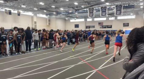Hartford Public Indoor Track Meet.  High school athletes racing neck and neck to the finish. 
