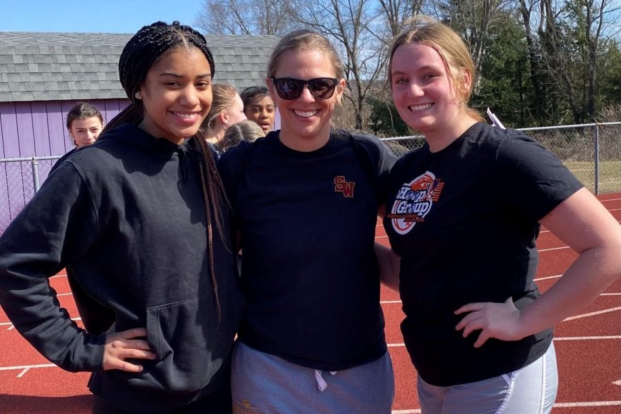 Senior Oliva Petgrave and junior Reagan Heafey-De Angelis with Coach Flachsbart  on the track.