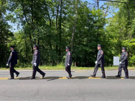 Marching in a line, South Windsor Fire Fighters join the 2023 Memorial Day Parade.
