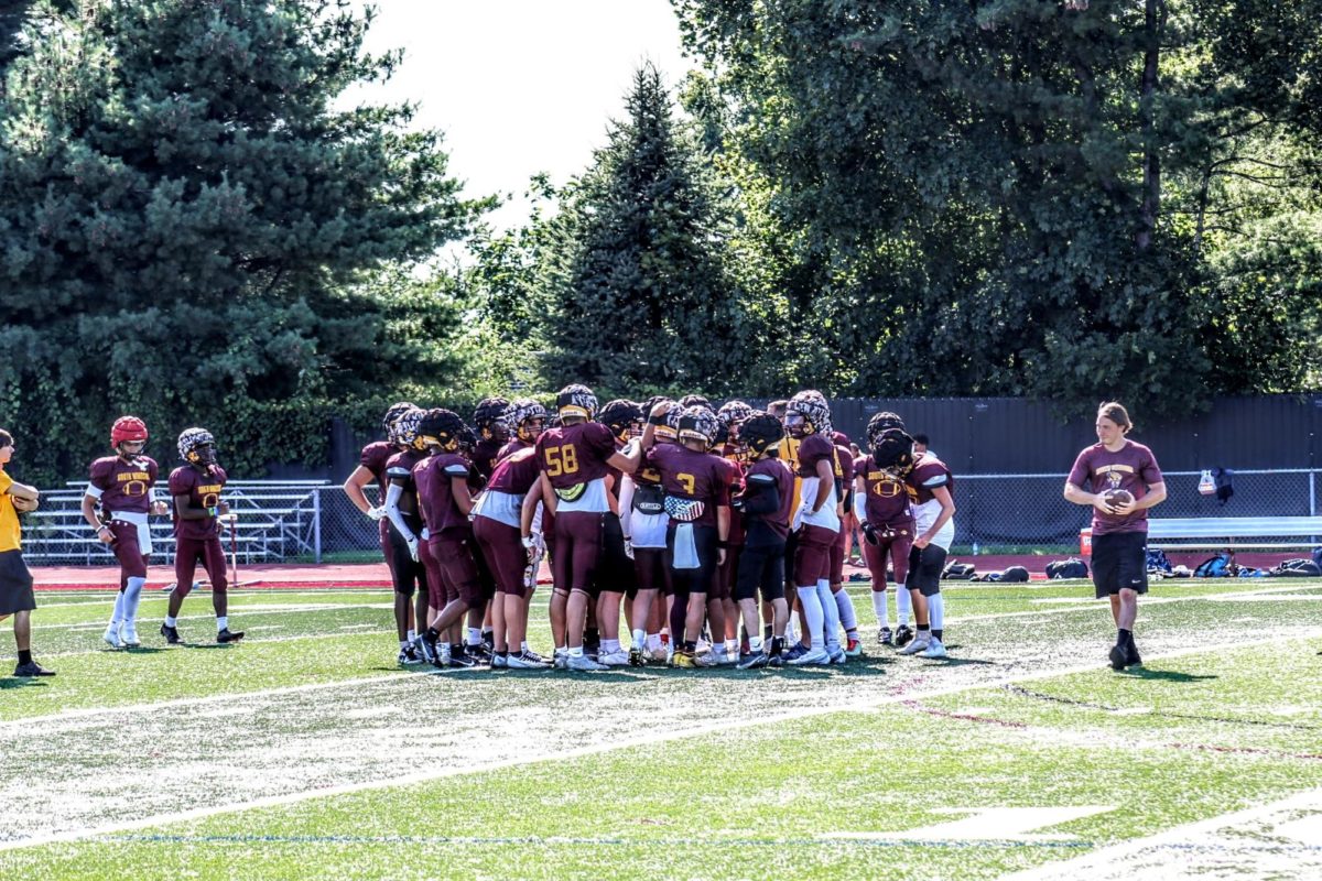 The South Windsor High School football team gathers together before their scrimmage against Hartford Public High School on Wednesday, August 23rd.	
