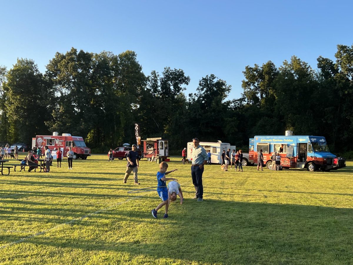 Food Trucks and Vendors line the field, providing concessions and merchandise during the concert.