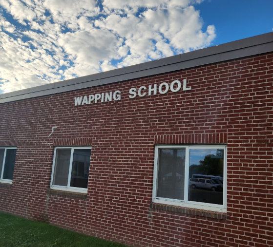 The light hits the Wapping School sign on an early Thursday morning.
