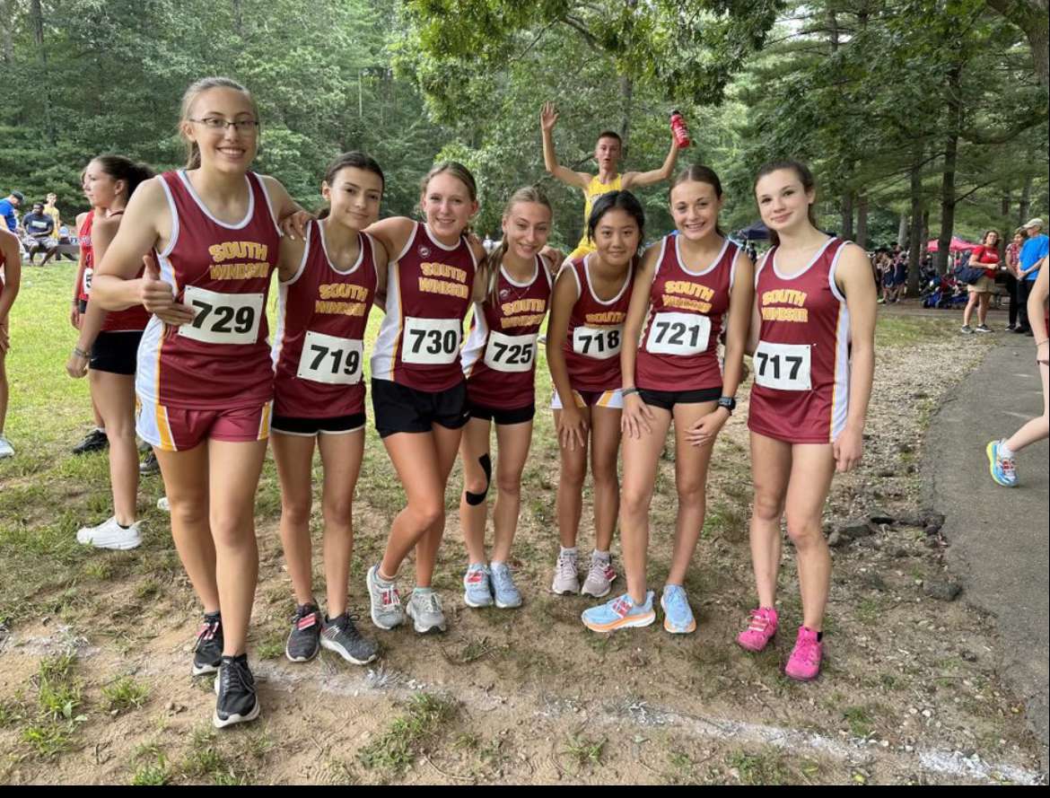 Some teammates from the SW girls cross country team posing for a photo before their race.