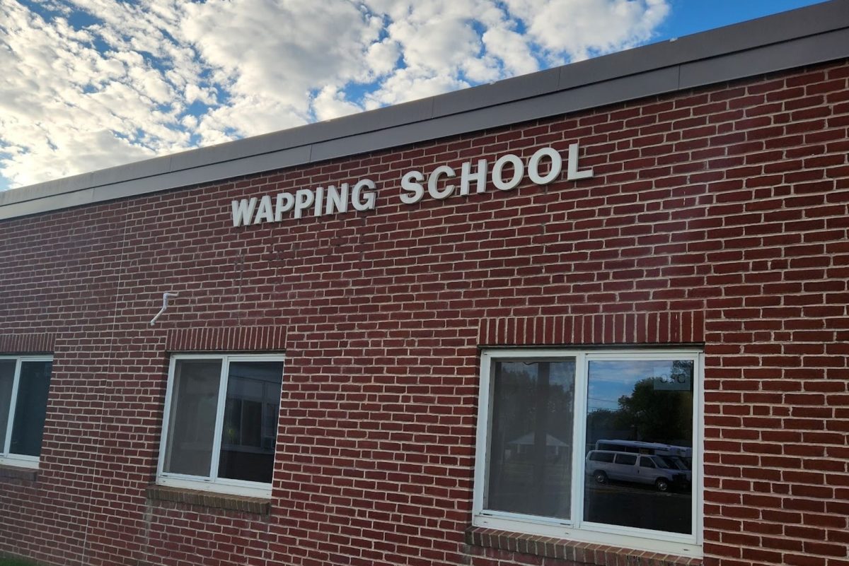 The light hits the Wapping School sign on an early Thursday morning.

