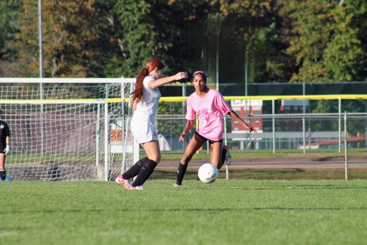 on the girls JV soccer team, freshman Annabel Ambooken steals the ball from a defender. 