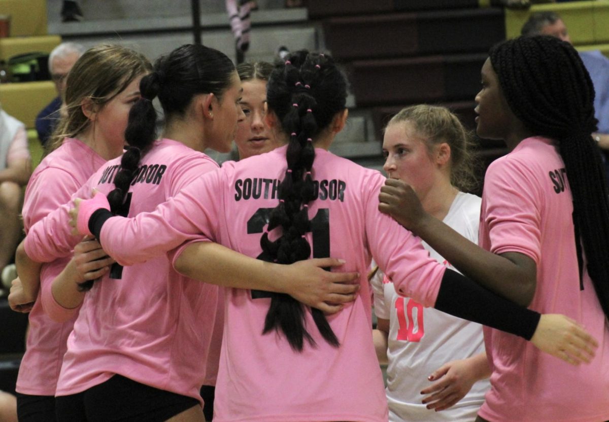 The lady bobcats huddle at center court to discuss the previous point.
