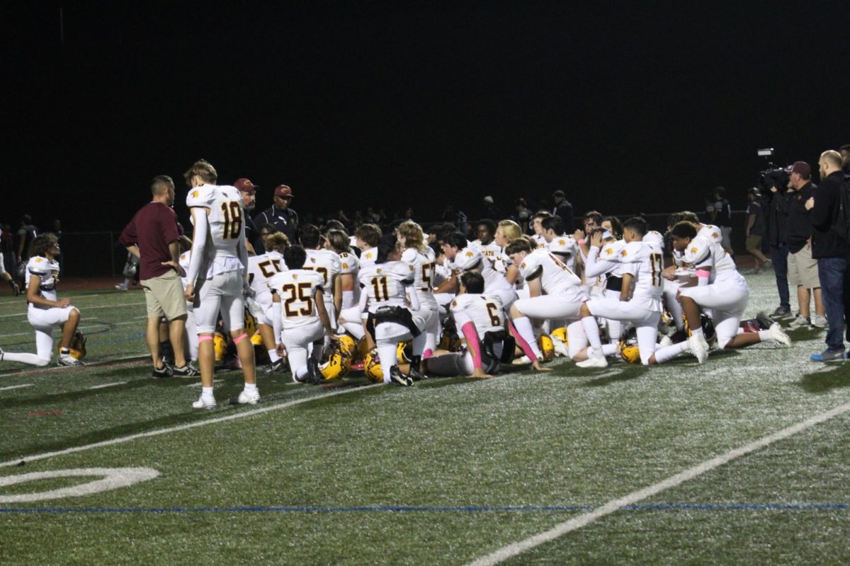 The South Windsor High School football team gathers together after their 28-12 win against Farmington