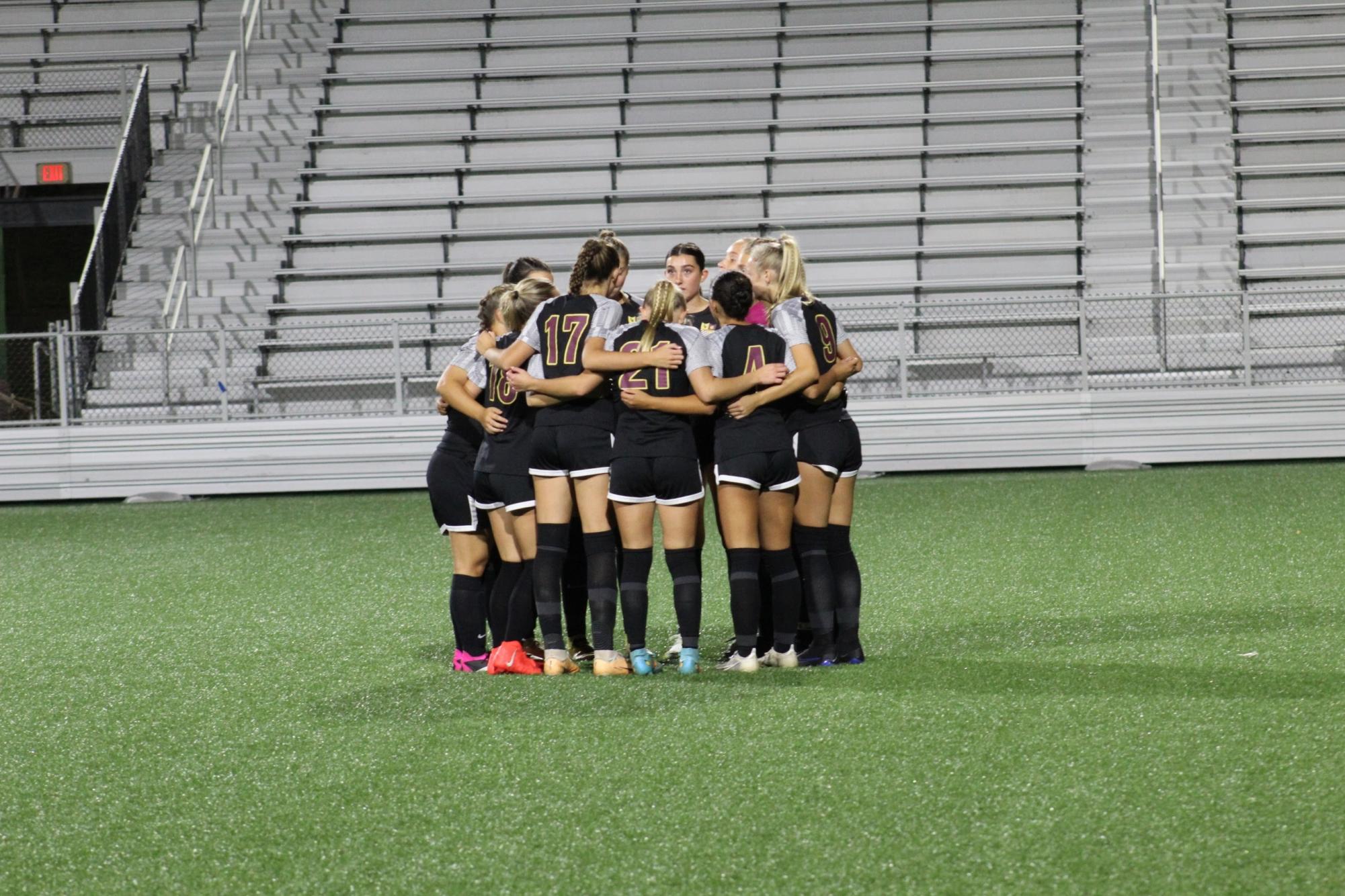 The girls soccer team embraces highlighting their solidarity during their senior night game against Enfield. The Bobcats won under the lights at Trinity Health Stadium 2-1.