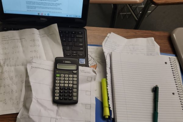 Unorganized assignments and trash strewn around a frantic student’s desk.
