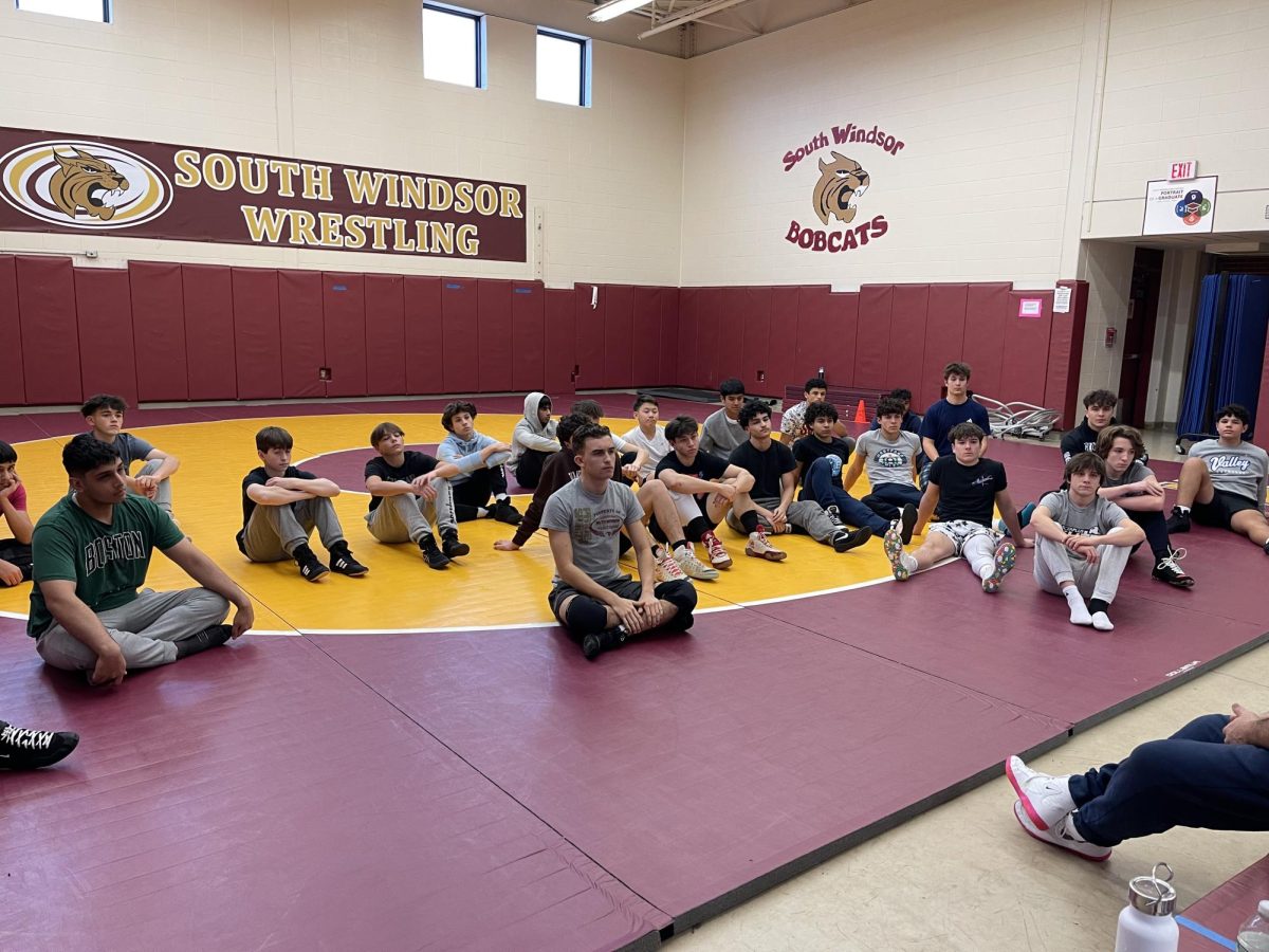 Coach Knapp giving his daily pre-practice speech to the wrestling team in the rubber room. 