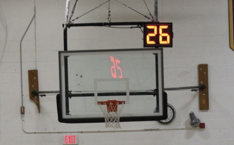  The newly introduced shot clock counts down during a varsity basketball game.