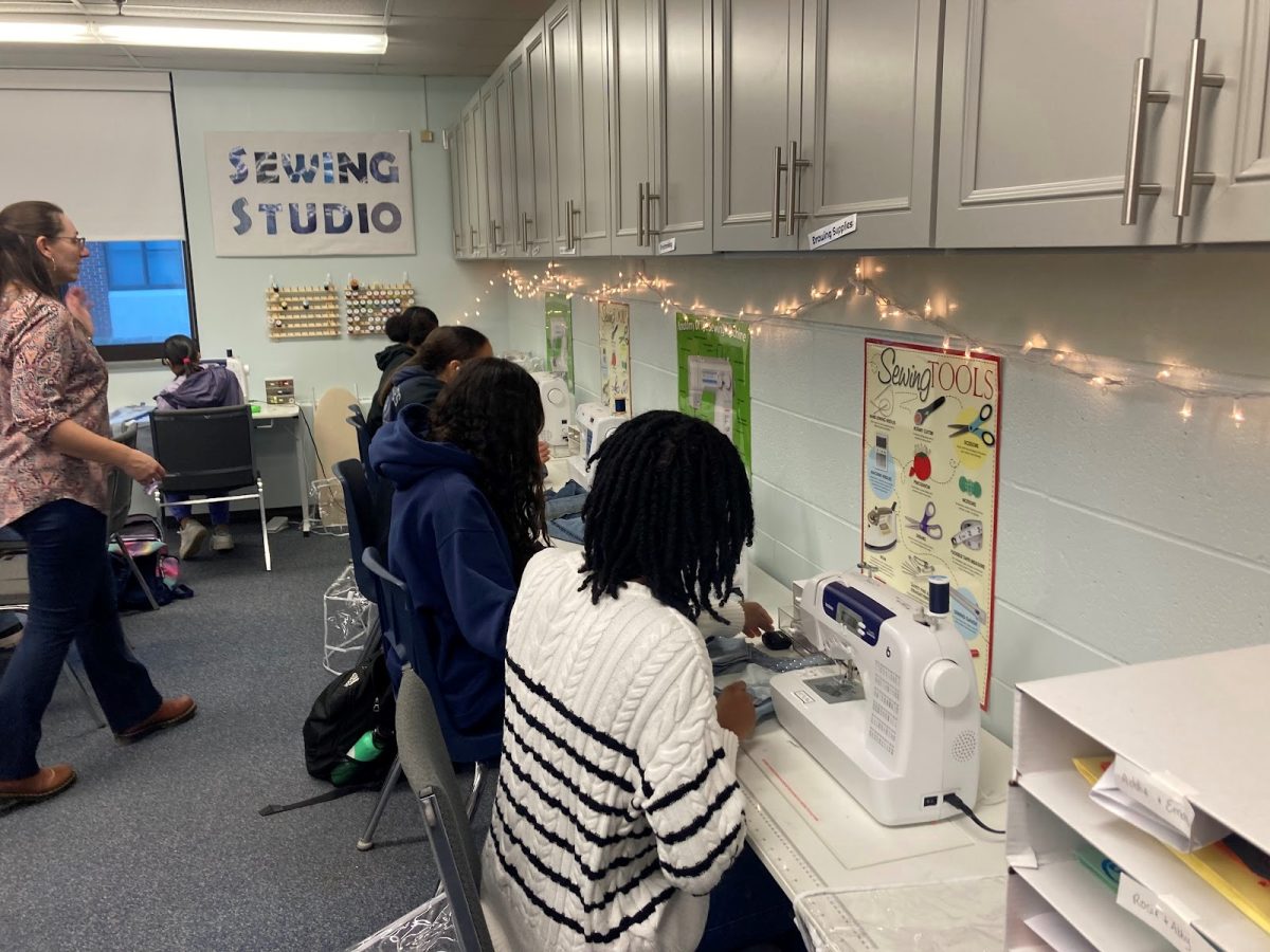 Students in Fashion Design class working at the sewing machines.