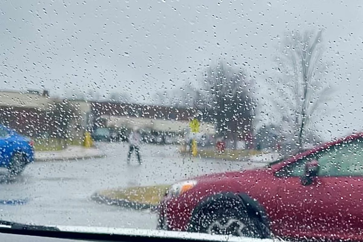 View from inside a car window approaching South Windsor High School amidst heavy rain and wind.