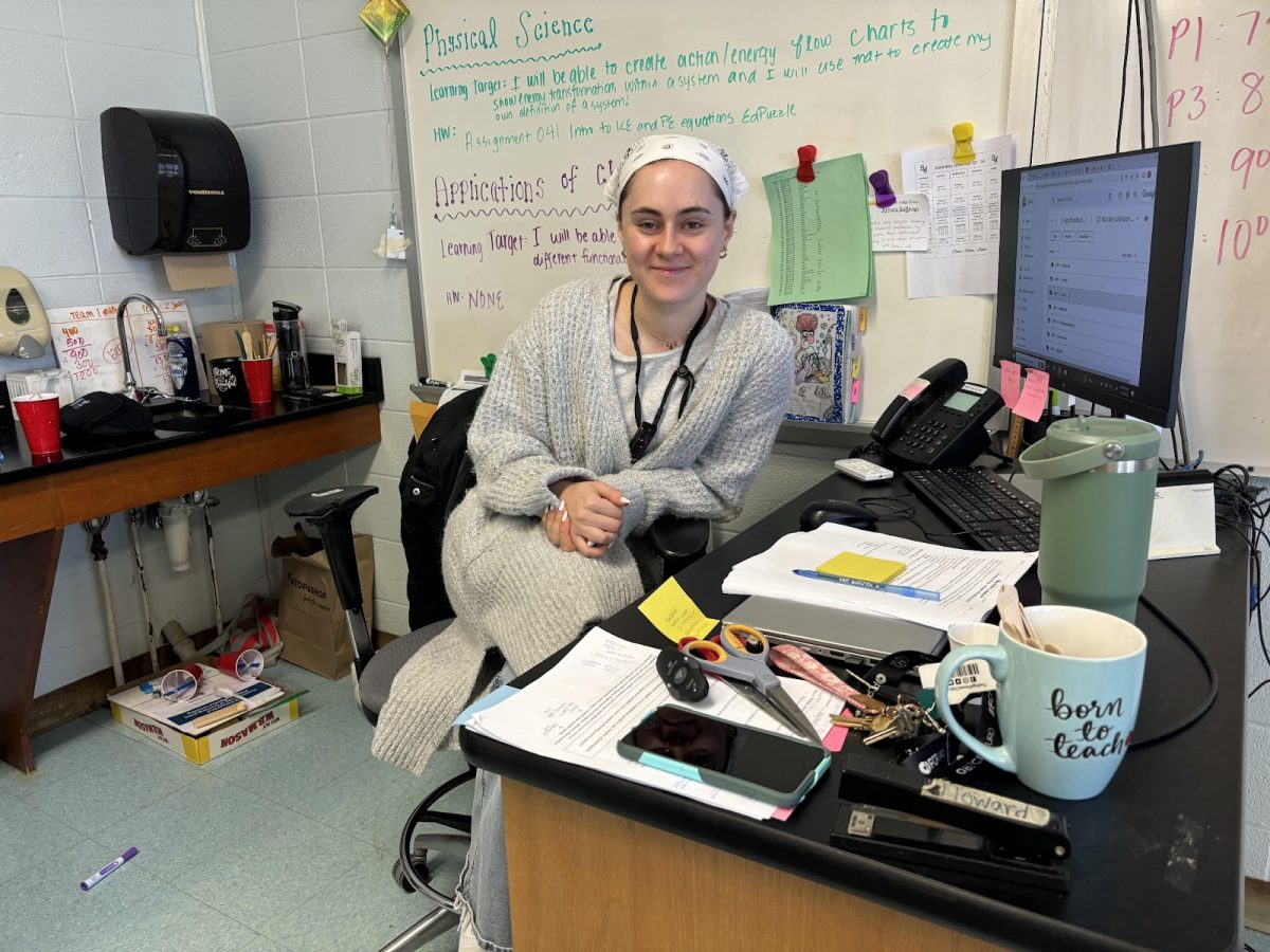 Science teacher, Ms. Tuxbury, working at her desk to create and plan lessons for her chemistry classes. 