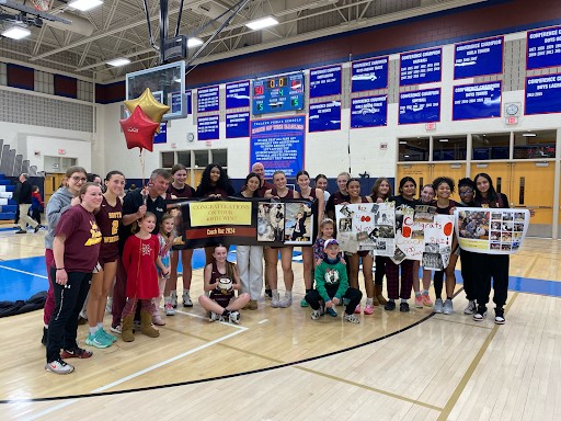 The girls basketball team celebrates Coach Raczkowskis 400th win after defeating Tolland. 