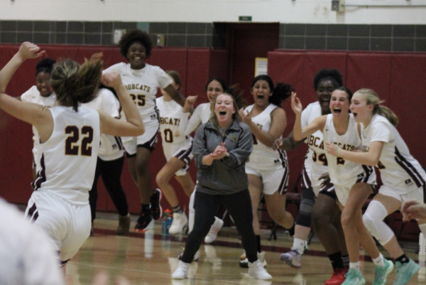 Coach Goslin and the South Windsor Girls JV team celebrate a big win in overtime against East Catholic.