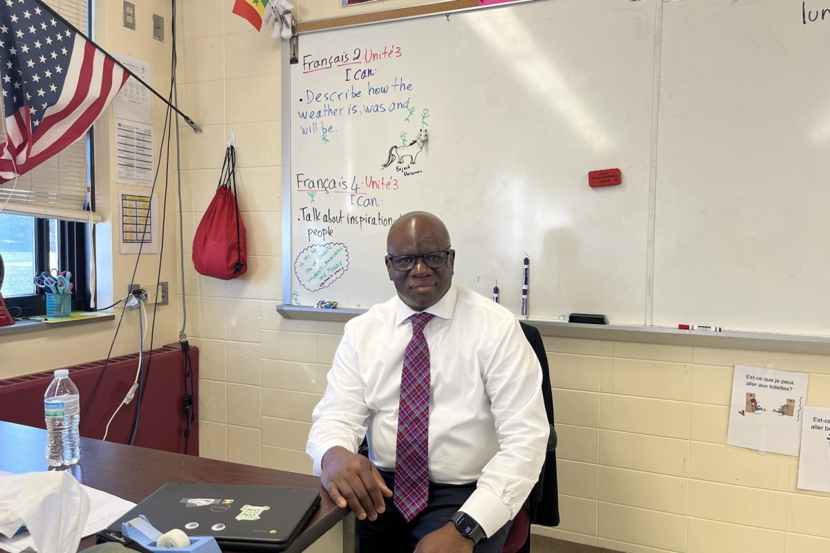 Mr. Ly in his world language classroom preparing for his French classes. 