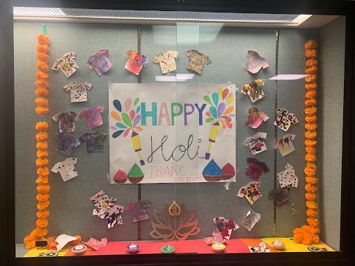 IHAC celebrating Holi by decorating a Holi-themed Showcase in SWHS.