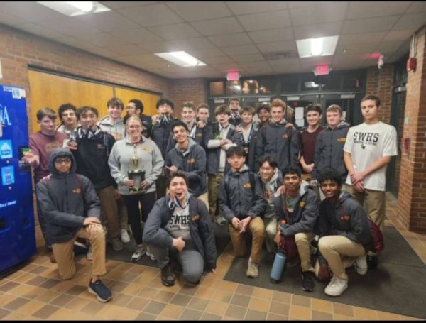 The South Windsor boys swim and dive team with their coach at Glastonbury High School. 