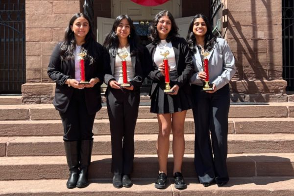 Freshman Pooravi Srivastava, Anouska Das, and juniors Mira Kannan and Smriti Rajan stand in front of the Old State House in Hartford with their awards. 