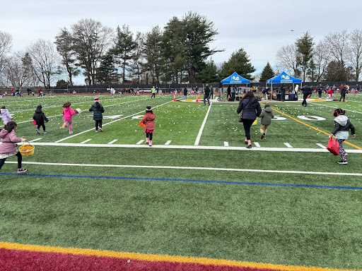 The first grade wave of kids ran to collect eggs at the Annual Egg Hunt.