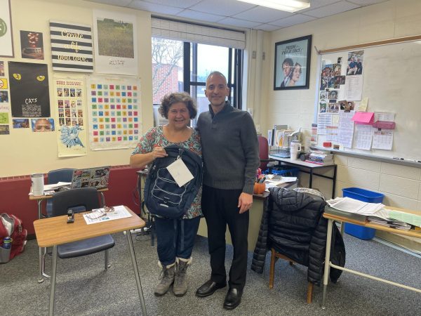 Mrs. White stands with Mr. Rizzuto after being notified that she received a grant to travel abroad.    