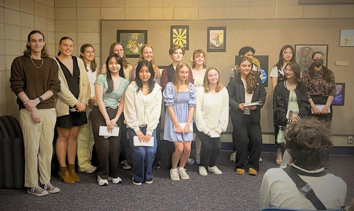 Senior art students pose after receiving their certificates and awards.