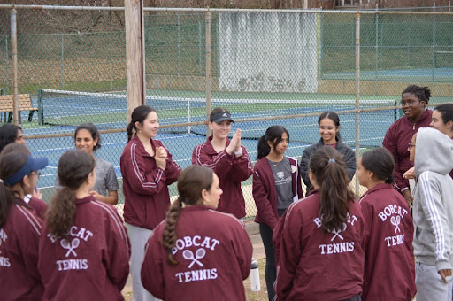 Girls tennis gives a pep talk before a home match. 