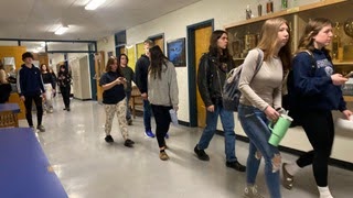 Students spaciously walking to their next class in Washburn High School.