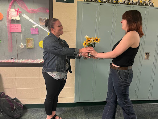 A South Windsor High School student handing mom and math teacher, Margaret Shea, flowers in celebration of mothers day.