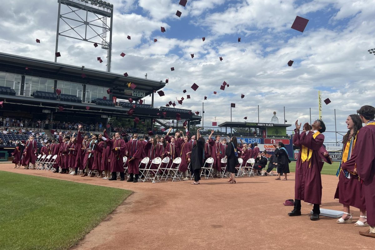 Last year's graduating class throws up their caps at the end of the ceremony in Dunkin Park. (Mrs. Quinn)