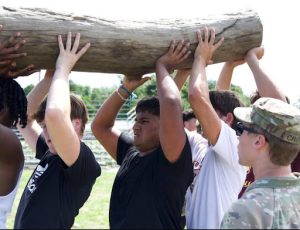 The bobcat senior captains carrying the log for their team.
