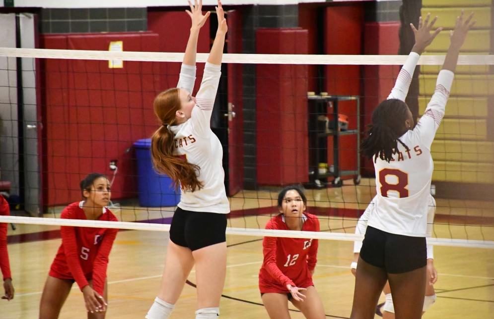 Senior Renee Gough and junior Kailie Girard preform a block during Friday's game against Manchester High School. (Kailie Girard)