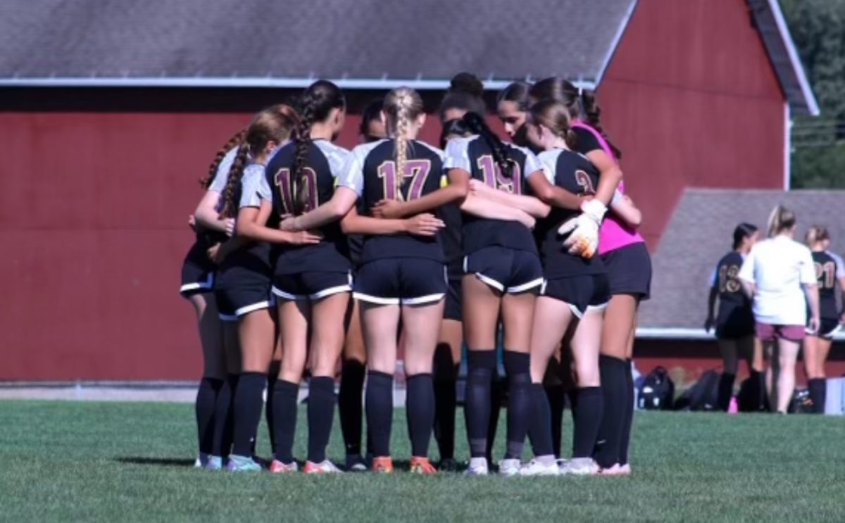 The South Windsor High School girls varsity team huddles before their opening game.