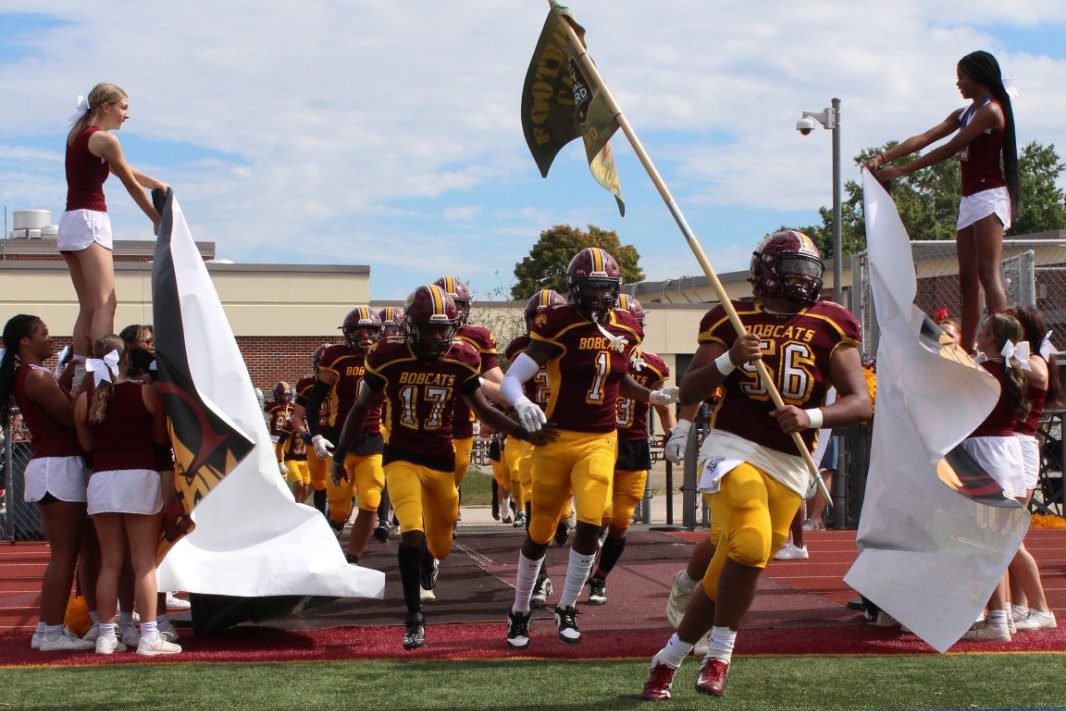 South Windsor High School Bobcats rush onto the field to start Saturday's game against Stamford. 