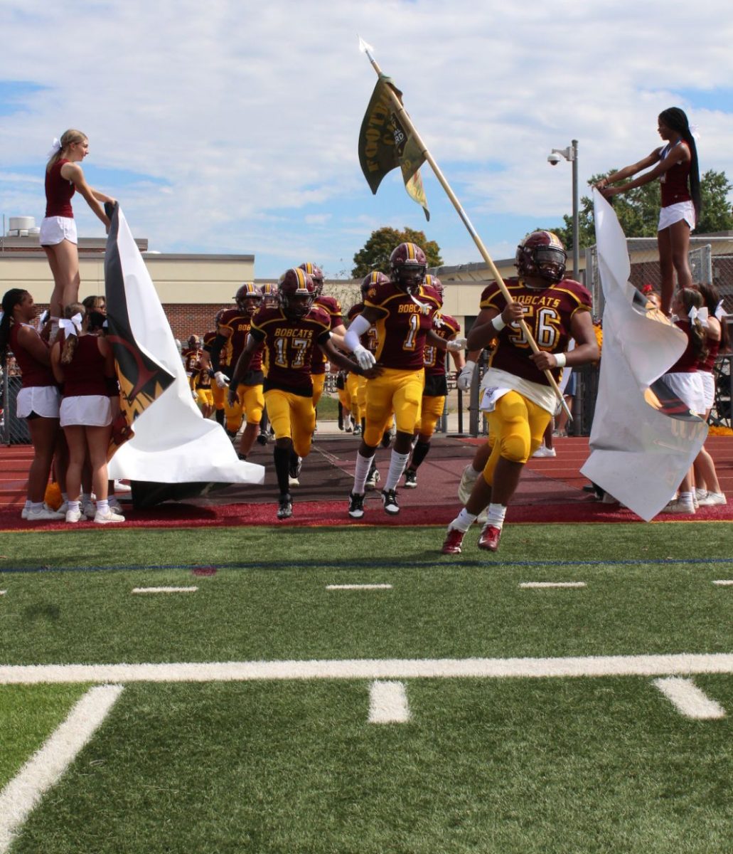 South Windsor High School Bobcats rush onto the field to start Saturday's game against Stamford. 