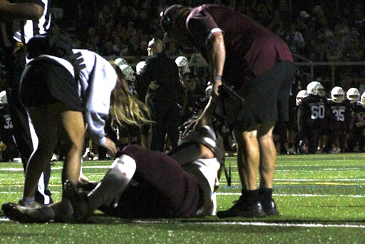 Robinson rushes onto the field to tend to Nathan Tenney’s injury during a game against Bristol Central.