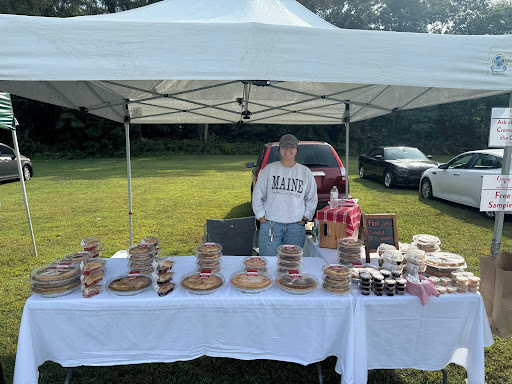 A vendor at The South Windsor Farmer's Market offering pies to market visitors. 