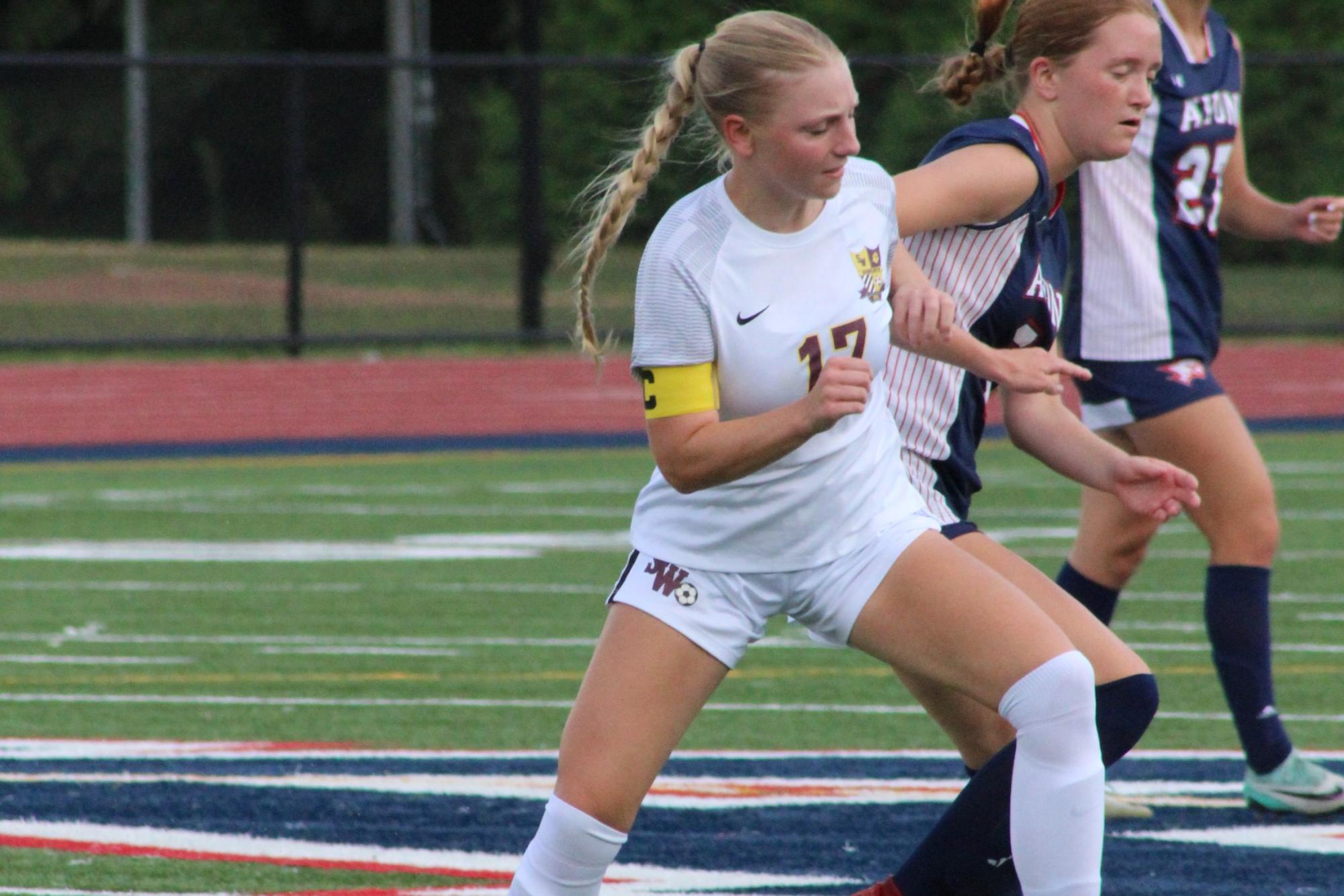 Senior center defensive mid Ava Hapkiewicz battling for the ball with an Avon player. 