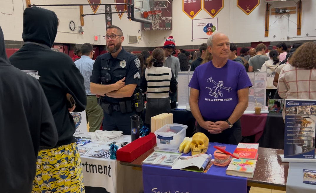 Vendors from colleges set up tables at the college fair for students to obtain information and ask questions. 